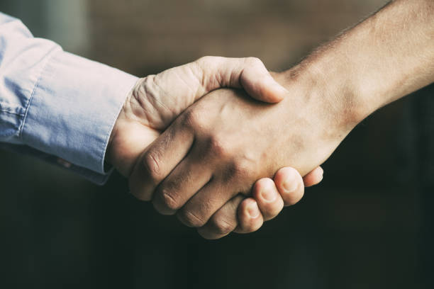 istock Closeup of Two Business Men Shaking Hands 894344516