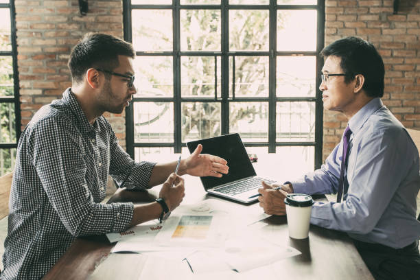 istock Business Partners Negotiating and Sitting Opposite 894344646