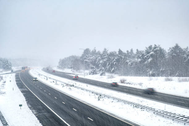 istock Traffic on a highway during a snow blizzard in winter 894345096