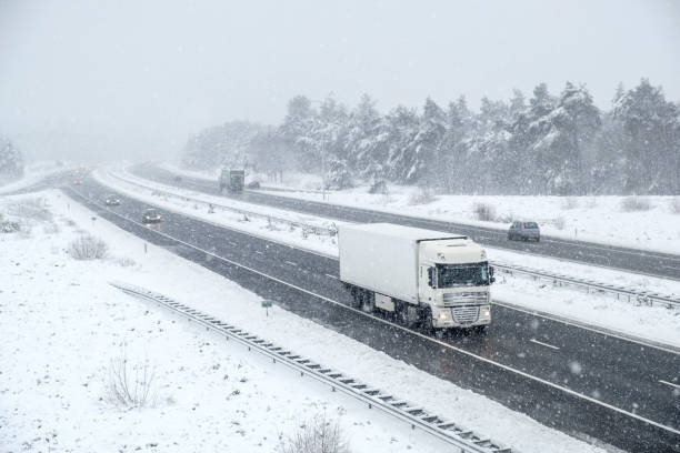 istock Traffic on a highway during a snow blizzard in winter 894345158