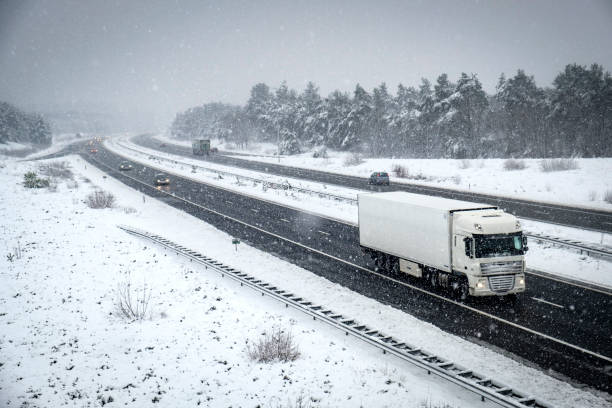 istock Traffic on a highway during a snow blizzard in winter 894346680