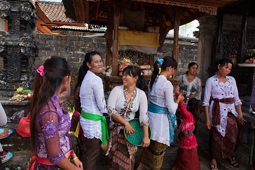 Bali, Indonesia - August 28,2012: Women laughing at national Galungan ceremony in the courtyard of the family temple