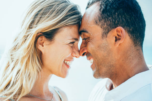 istock Closeup of Laughing Couple Touching Foreheads 894347882