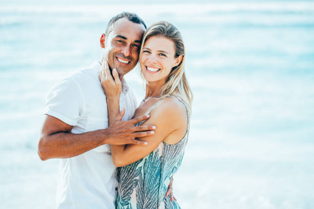 istock Loving Couple Embracing on Summer Sea Beach 894347978