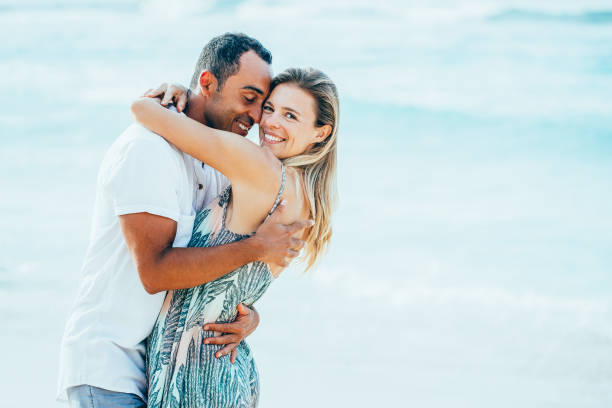 istock Loving Couple Embracing on Summer Beach 894347990