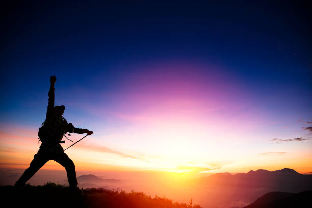 man on the mountain and watching sunrise