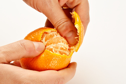 Male Hand Peeling a Mandarin