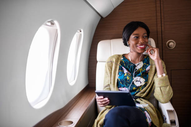istock Woman in private jet airplane 894355744