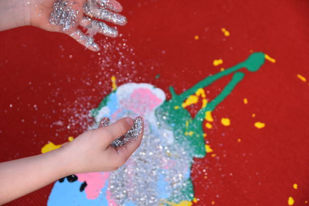 istock Abstract art, a girl spraying paint on canvas 894360968