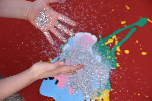 istock Abstract art, a girl spraying paint on canvas 894360970