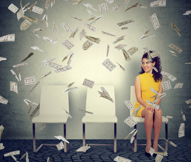 istock Woman sitting in flying bills 894361346