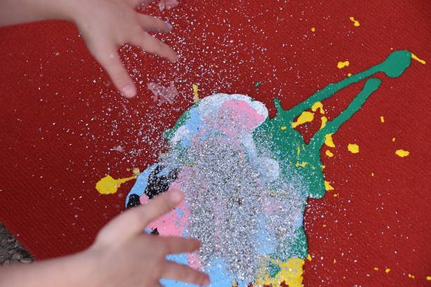 istock Abstract art, a girl spraying paint on canvas 894361718