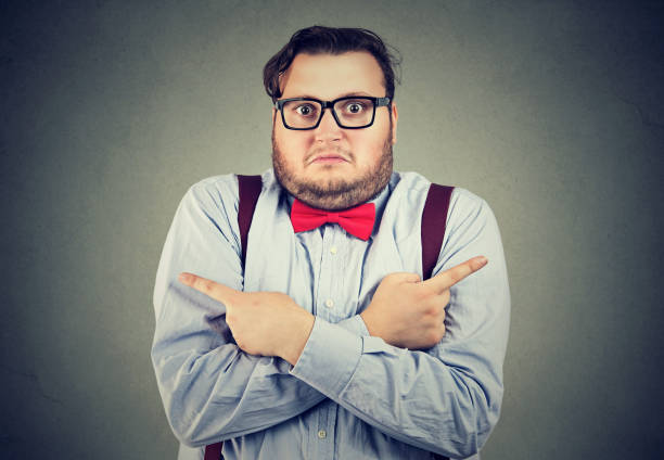 istock Puzzled man pointing around and above 894365998