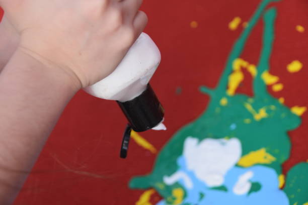 istock Abstract art, a girl spraying paint on canvas 894368756