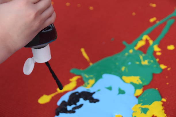 istock Abstract art, a girl spraying paint on canvas 894368774
