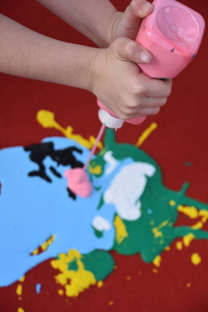 istock Abstract art, a girl spraying paint on canvas 894371964