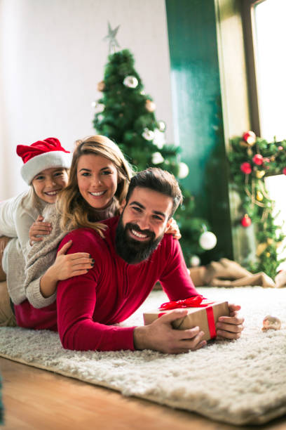 istock Family celebrating Christmas at home. 894372120