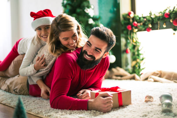 istock Family celebrating Christmas at home. 894372230