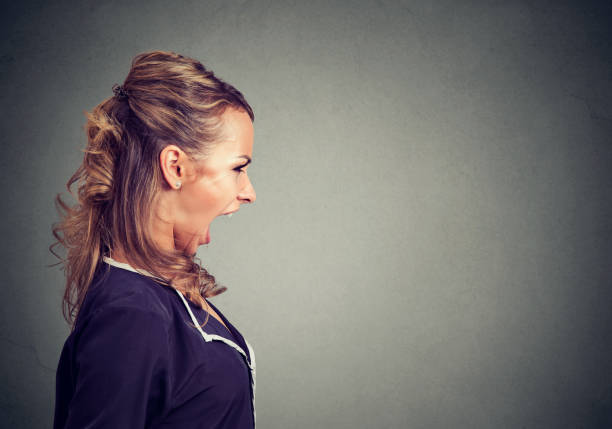 istock Screaming female boss on gray 894372910