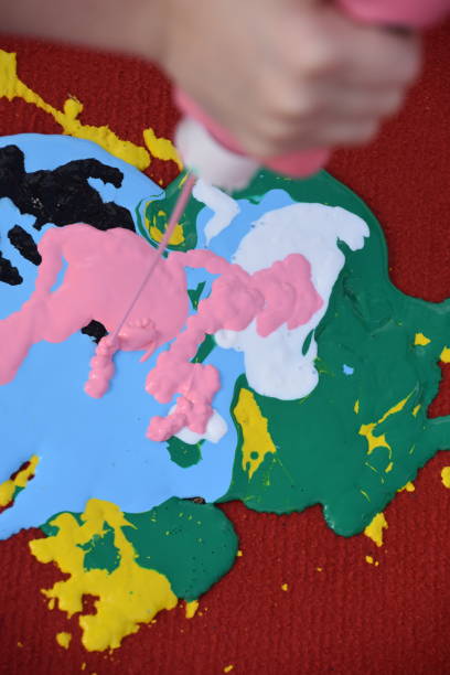 istock Abstract art, a girl spraying paint on canvas 894373100