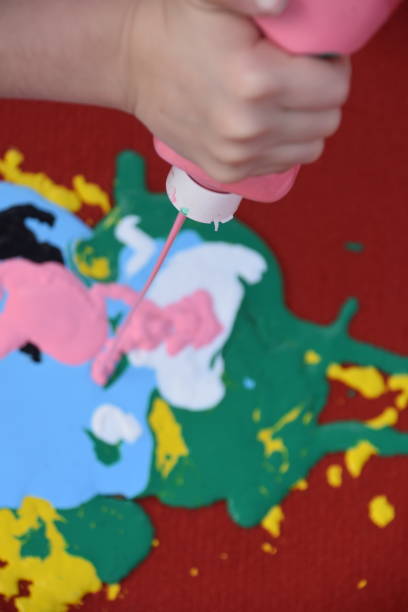 istock Abstract art, a girl spraying paint on canvas 894373136