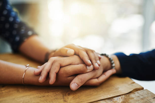 Be of those who lend a hand where they can Closeup shot of two unrecognizable people holding hands in comfort grief stock pictures, royalty-free photos & images