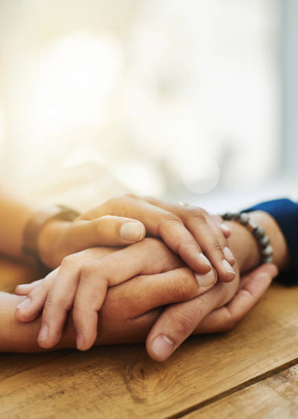 Help will always be within reach Closeup shot of two unrecognizable people holding hands in comfort consoling stock pictures, royalty-free photos & images