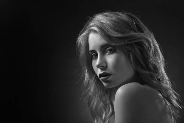 istock Beautiful woman on dark background . 894377766