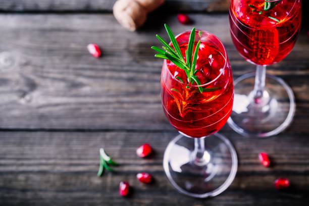 Pomegranate champagne mimosa cocktail with rosemary