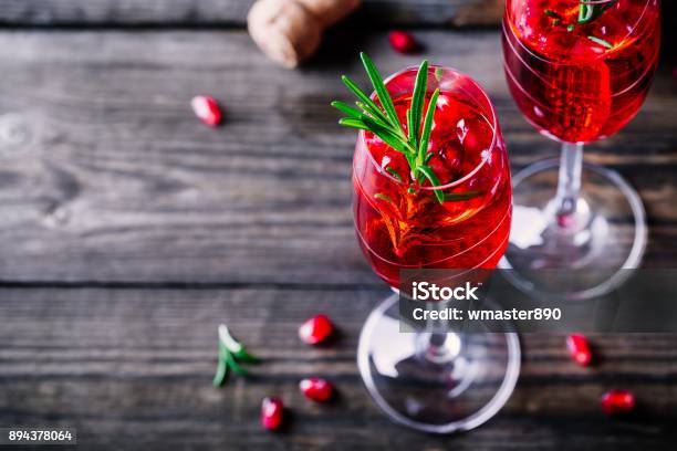 Pomegranate Champagne Mimosa Cocktail With Rosemary Stock Photo - Download Image Now