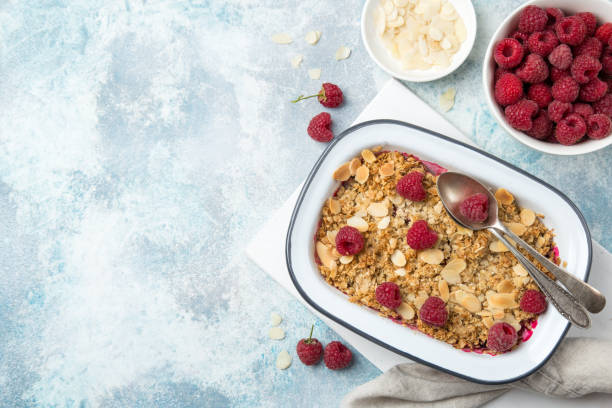 istock raspberry oats crumble pie served with fresh berries and almond flakes 894378122