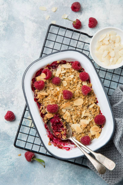 istock raspberry oats crumble pie served with fresh berries and almond flakes 894378124