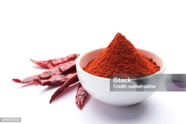 Red Chilli Powder In A Bowl With Dried Red Chillies Over Colourful Background Or Pile Of Red Chilli Powder Over Plain Background Stock Photo - Download Image Now