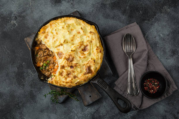 shepherd's pie. Minced meat, mashed potatoes and vegetables casserole in cast iron pan stock photo
