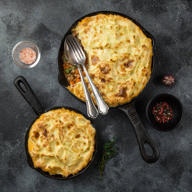 istock shepherd's pie. Minced meat, mashed potatoes and vegetables casserole in cast iron pan 894383358