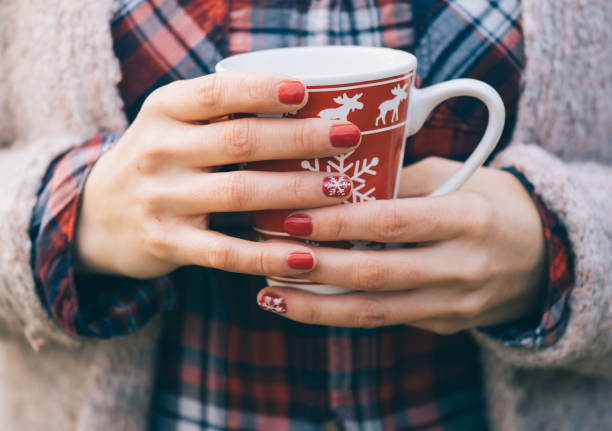 istock Tea mug in female hands 894388382