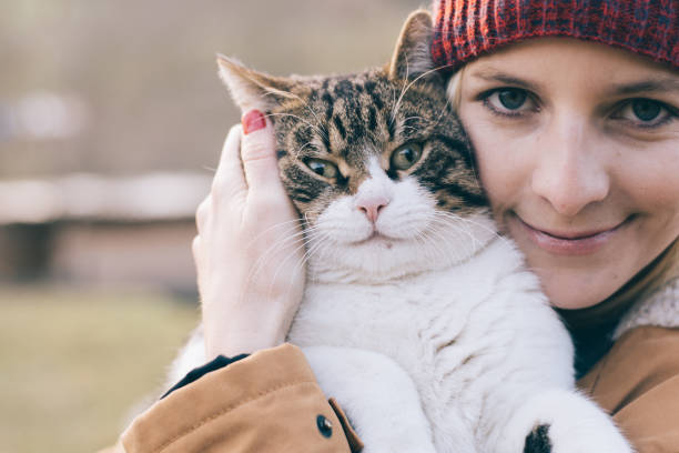 istock Woman and her cat playing outdoor 894392518