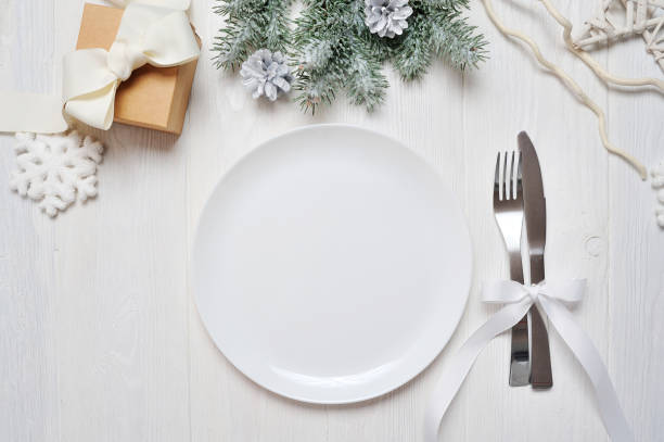 istock Christmas table setting on white wooden table. Christmas card template with space for your text, top view 894400272