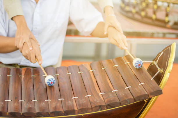 istock Beautiful Asian Teacher teaching students to practice Thai instruments 894405782