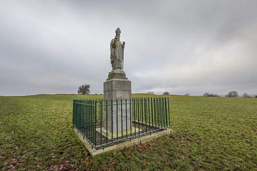 A christian symbol statue of St Patrick standing in a field at the Hill of Tara, County Meath, Ireland