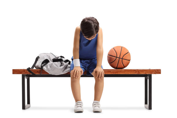 istock Sad little basketball player sitting on a bench 894412636