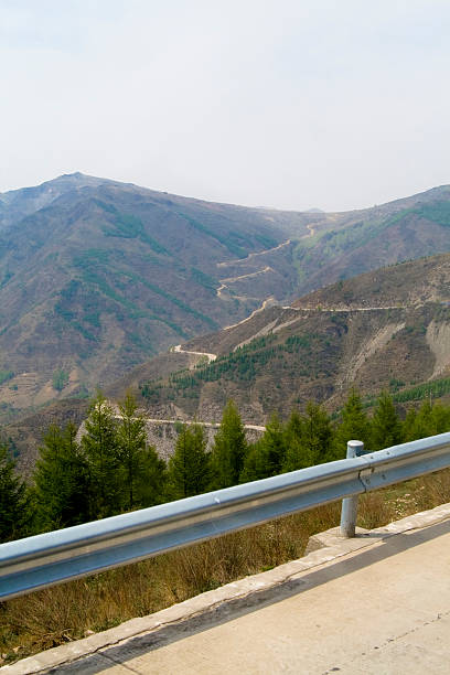 Winding road up mountain stock photo