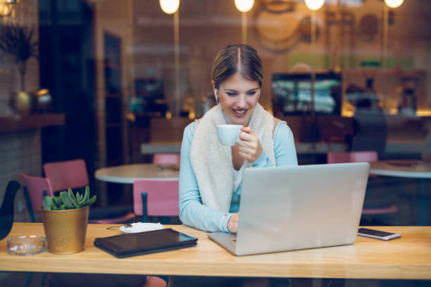 istock Trendy blogger typing on laptop in cafe. 894420730