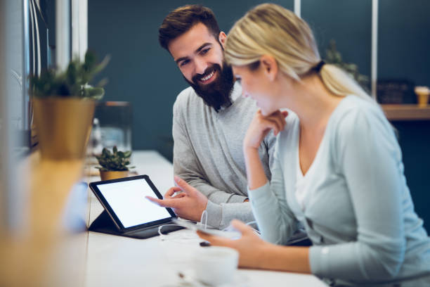 istock Couple sitting in cafe with digital tablet and web surfing 894421058