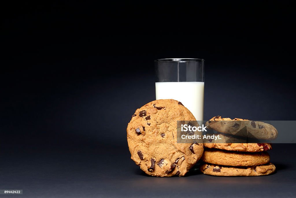 Latte e biscotti su nero - Foto stock royalty-free di Latte