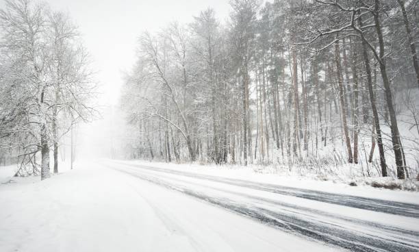 istock Snowy winter road during blizzard in Latvia 894425742