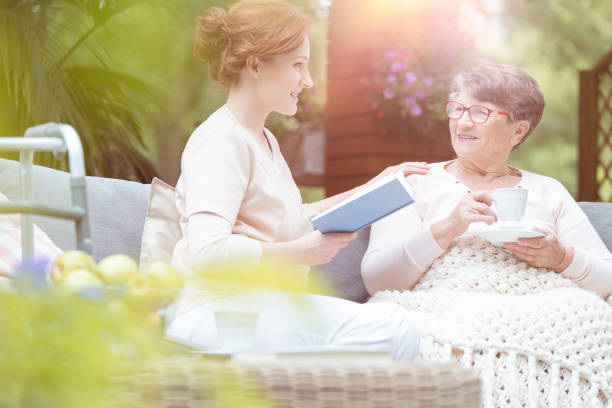 istock Senior and caregiver on terrace 894429212