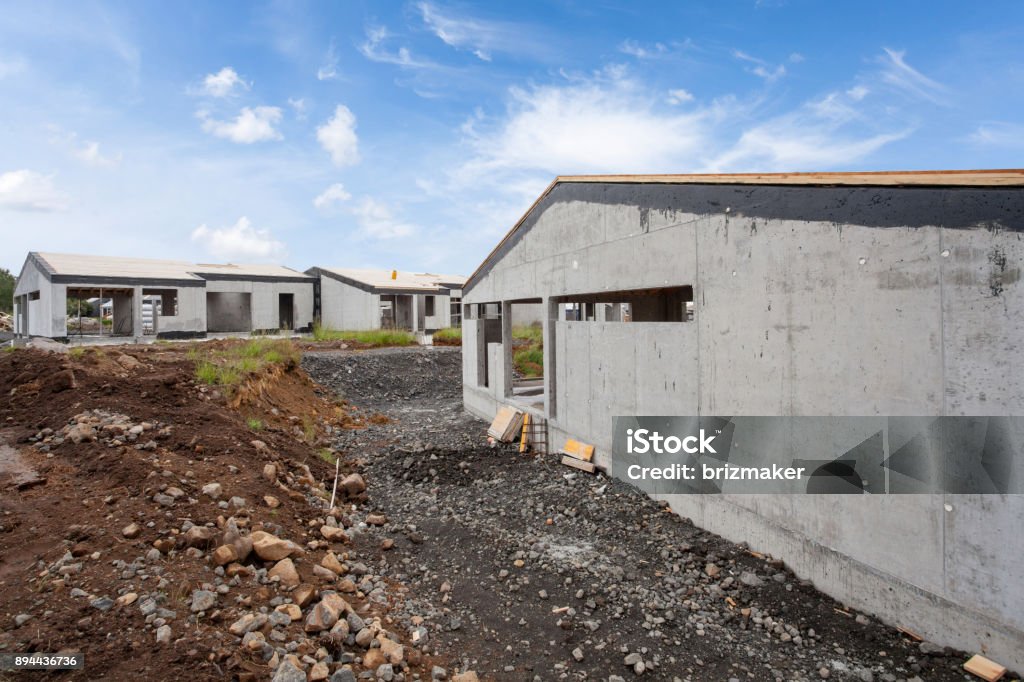 Construction of building of new white concrete house with 
incomplete wooden roof Construction of building of new white concrete house with  Architecture Stock Photo
