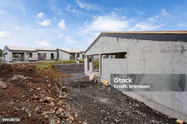 Construction Of Building Of New White Concrete House With Incomplete Wooden Roof Stock Photo - Download Image Now