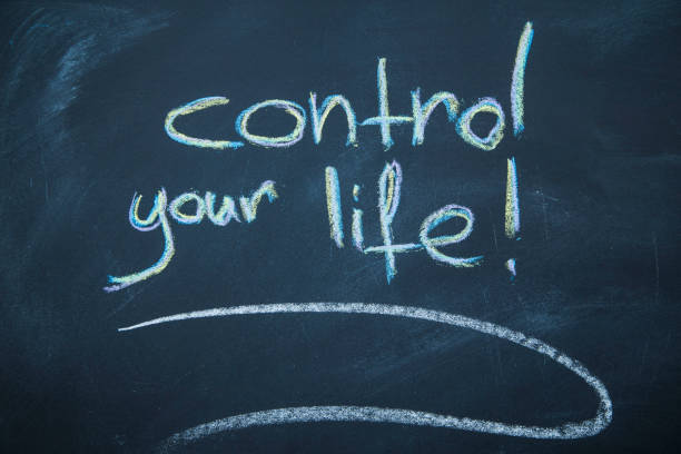 istock Control your life inscription on a blackboard 894436906